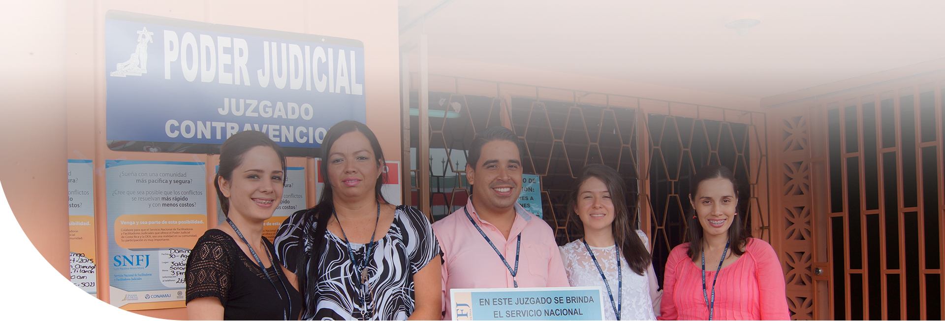 Personas sonriendo y mostrando rótulo de que ese juzgado ofrece el servicio de SNFJ